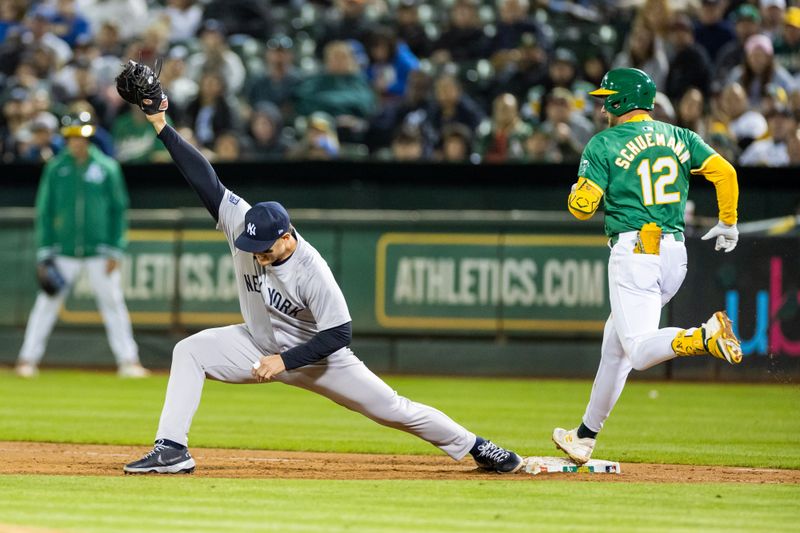 Sep 20, 2024; Oakland, California, USA; Oakland Athletics shortstop Max Schuemann (12) is thrown out at first during the ninth inning against the New York Yankees at Oakland-Alameda County Coliseum. Mandatory Credit: Bob Kupbens-Imagn Images