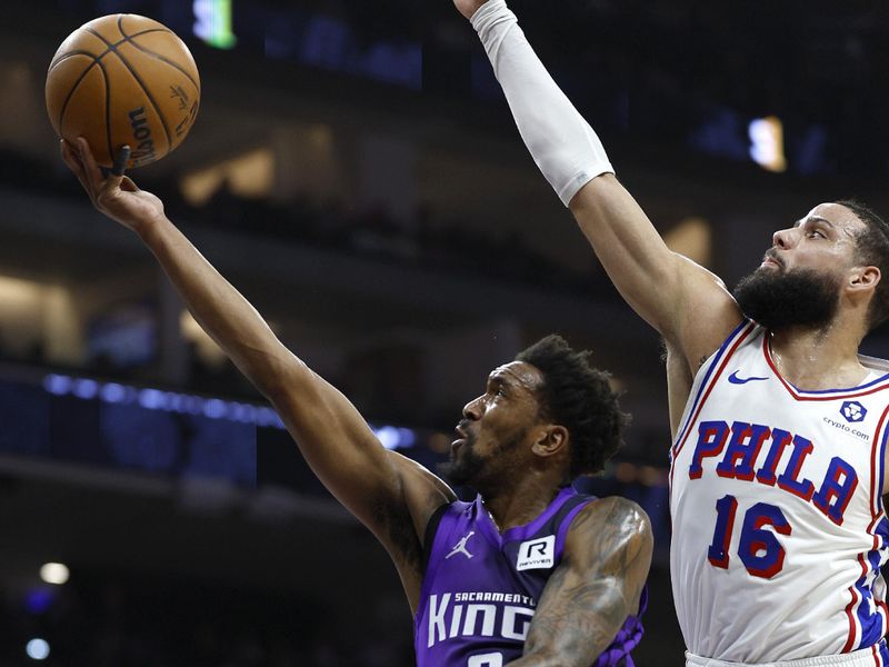 SACRAMENTO, CALIFORNIA - JANUARY 01: Malik Monk #0 of the Sacramento Kings driving to the basket shoots over Caleb Martin #16 of the Philadelphia 76ers during the first half of an NBA basketball game at Golden 1 Center on January 01, 2025 in Sacramento, California. NOTE TO USER: User expressly acknowledges and agrees that, by downloading and or using this photograph, User is consenting to the terms and conditions of the Getty Images License Agreement. (Photo by Thearon W. Henderson/Getty Images)