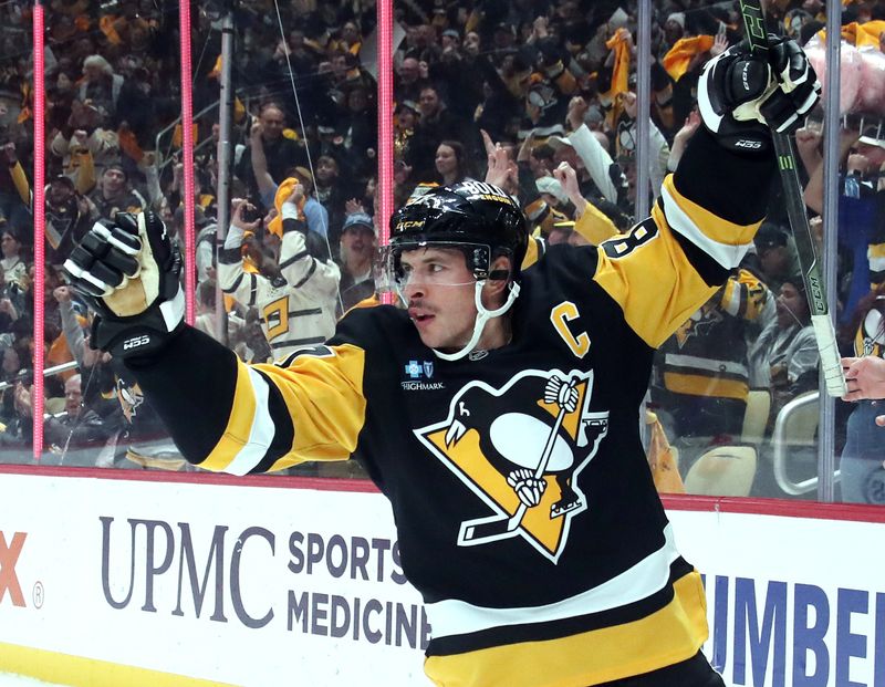 Nov 2, 2024; Pittsburgh, Pennsylvania, USA;  Pittsburgh Penguins center Sidney Crosby (87) reacts after scoring a goal against the Montreal Canadiens during the first period at PPG Paints Arena. Mandatory Credit: Charles LeClaire-Imagn Images