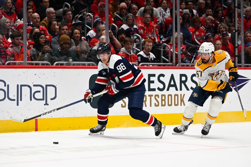 Dec 30, 2023; Washington, District of Columbia, USA; Washington Capitals right wing Nicolas Aube-Kubel (96) controls the puck as Nashville Predators defenseman Dante Fabbro (57) defends during the first period at Capital One Arena. Mandatory Credit: Brad Mills-USA TODAY Sports