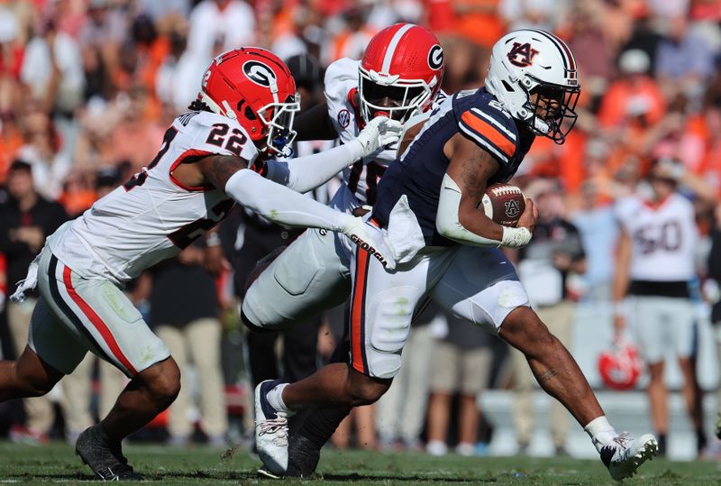 Sep 30, 2023; Auburn, Alabama, USA; Georgia Bulldogs defensive back Javon Bullard (22) looks to tackle Auburn Tigers running back Jarquez Hunter (27) during the second quarter at Jordan-Hare Stadium. Mandatory Credit: John Reed-USA TODAY Sports