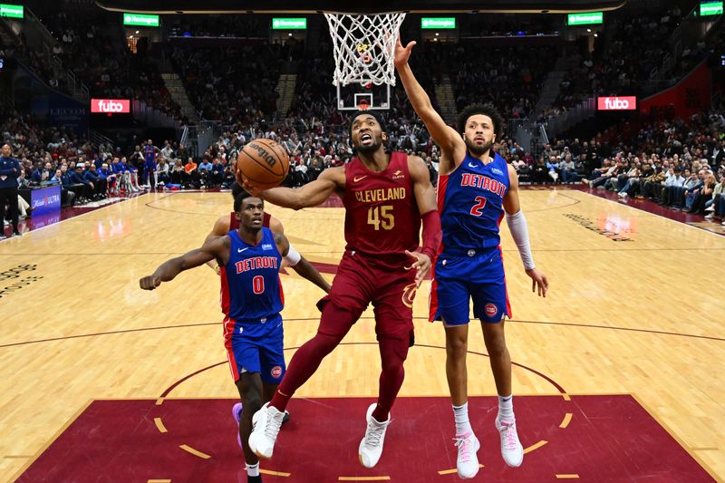 CLEVELAND, OHIO - JANUARY 31: Donovan Mitchell #45 of the Cleveland Cavaliers goes up for a shot against Cade Cunningham #2 of the Detroit Pistons during the fourth quarter at Rocket Mortgage Fieldhouse on January 31, 2024 in Cleveland, Ohio. The Cavaliers defeated the Pistons 128-121. (Photo by Jason Miller/Getty Images) NOTE TO USER: User expressly acknowledges and agrees that, by downloading and or using this photograph, User is consenting to the terms and conditions of the Getty Images License Agreement. (Photo by Jason Miller/Getty Images)