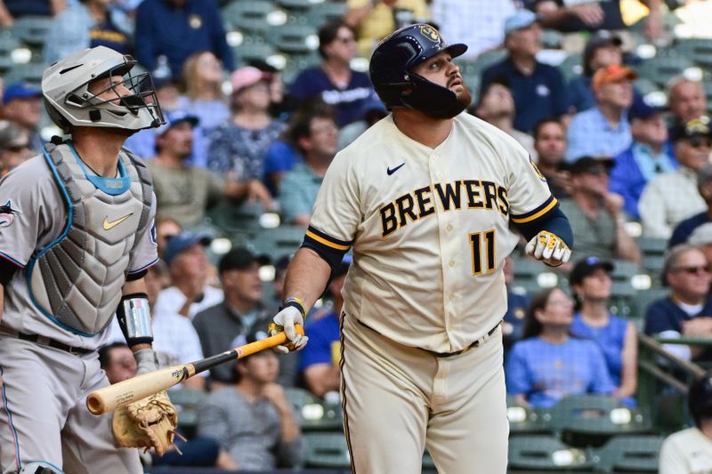 Sep 14, 2023; Milwaukee, Wisconsin, USA; Milwaukee Brewers first baseman Rowdy Tellez (11) watches after hitting a sacrifice fly against the Miami Marlins in the fourth inning at American Family Field. Mandatory Credit: Benny Sieu-USA TODAY Sports