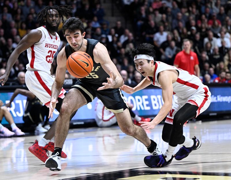 Jan 13, 2023; West Lafayette, Indiana, USA; Purdue Boilermakers guard Ethan Morton (25) loses control of the ball against Nebraska Cornhuskers guard Keisei Tominaga (30) during the second half at Mackey Arena. Boilermakers won 73 to 55. Mandatory Credit: Marc Lebryk-USA TODAY Sports