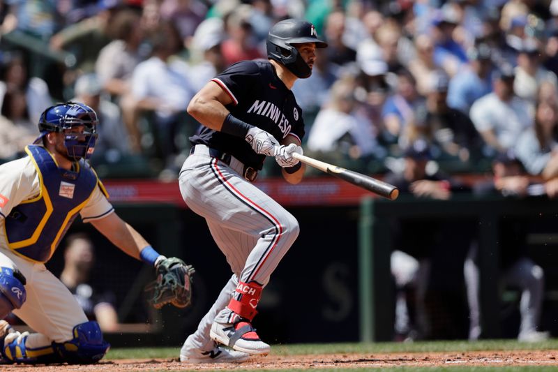 Jun 1, 2025; Seattle, Washington, USA; Minnesota Twins right fielder Trevor Larnach (9) hits a single against the Seattle Mariners during the fifth inning at T-Mobile Park. Mandatory Credit: John Froschauer-Imagn Images