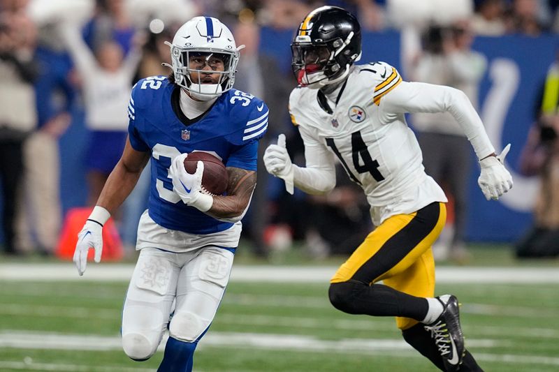 Indianapolis Colts safety Julian Blackmon (32) runs after intercepting a pass intended for Pittsburgh Steelers wide receiver George Pickens (14) during the second half of an NFL football game in Indianapolis Saturday, Dec. 16, 2023. (AP Photo/Darron Cummings)