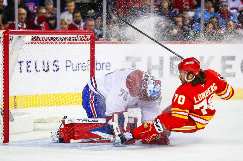 Oct 22, 2025; Calgary, Alberta, CAN; Montreal Canadiens goaltender Jakub Dobes (75) and Calgary Flames left wing Ryan Lomberg (70) collides during the second period at Scotiabank Saddledome. Mandatory Credit: Sergei Belski-Imagn Images