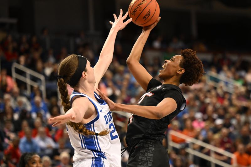 Mar 4, 2023; Greensboro, NC, USA; Virginia Tech Hokies forward D'asia Gregg (11) shoots over Duke Blue Devils center Kennedy Brown (21) during the first half at Greensboro Coliseum. Mandatory Credit: William Howard-USA TODAY Sports