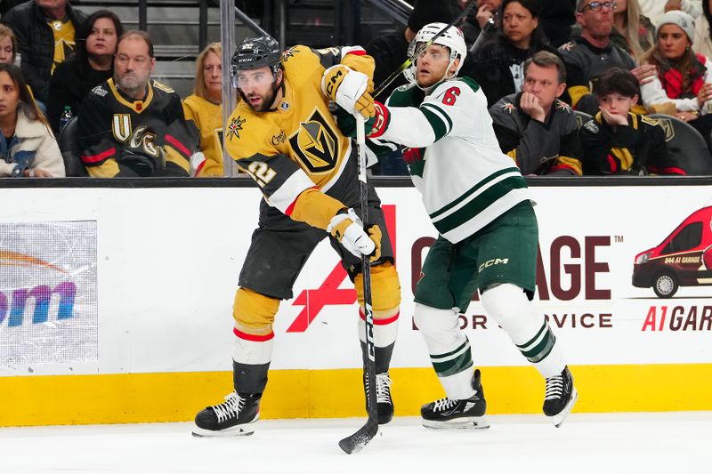 Feb 12, 2024; Las Vegas, Nevada, USA; Minnesota Wild defenseman Dakota Mermis (6) checks Vegas Golden Knights right wing Michael Amadio (22) during the second period at T-Mobile Arena. Mandatory Credit: Stephen R. Sylvanie-USA TODAY Sports