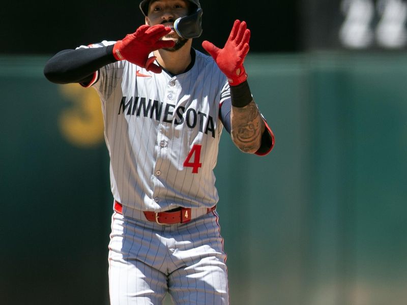 Jun 22, 2024; Oakland, California, USA; Minnesota Twins shortstop Carlos Correa (4) celebrates after hitting a double against the Oakland Athletics during the seventh inning at Oakland-Alameda County Coliseum. Mandatory Credit: D. Ross Cameron-USA TODAY Sports