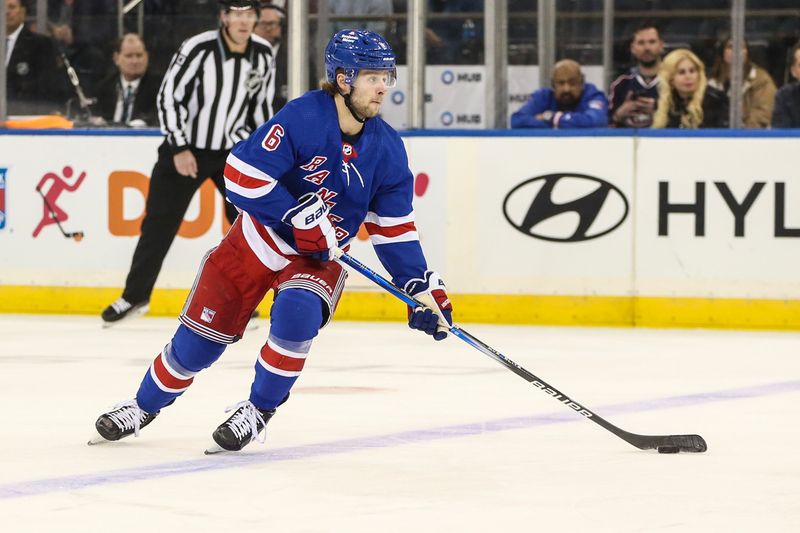 Nov 12, 2023; New York, New York, USA;  New York Rangers defenseman Zac Jones (6) controls the puck in the first period against the Columbus Blue Jackets at Madison Square Garden. Mandatory Credit: Wendell Cruz-USA TODAY Sports