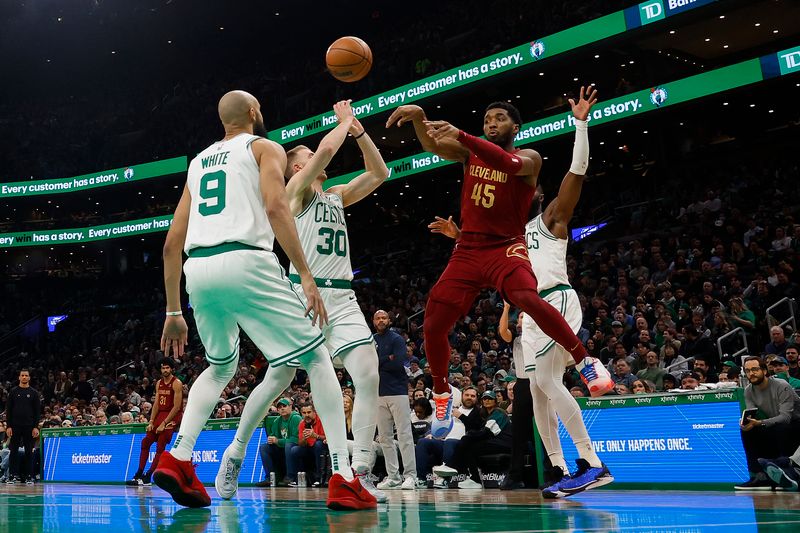 BOSTON, MA - DECEMBER 14: Donovan Mitchell #45 of the Cleveland Cavaliers throws a pass while surrounded by Boston Celtics during the second quarter at TD Garden on December 14, 2023 in Boston, Massachusetts. NOTE TO USER: User expressly acknowledges and agrees that, by downloading and/or using this Photograph, user is consenting to the terms and conditions of the Getty Images License Agreement. (Photo By Winslow Townson/Getty Images)