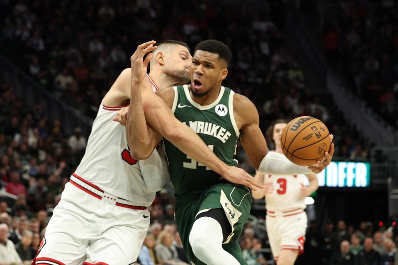 MILWAUKEE, WISCONSIN - NOVEMBER 20: Giannis Antetokounmpo #34 of the Milwaukee Bucks is fouled by Nikola Vucevic #9 of the Chicago Bulls during the second half of a game at Fiserv Forum on November 20, 2024 in Milwaukee, Wisconsin. NOTE TO USER: User expressly acknowledges and agrees that, by downloading and or using this photograph, User is consenting to the terms and conditions of the Getty Images License Agreement. (Photo by Stacy Revere/Getty Images)