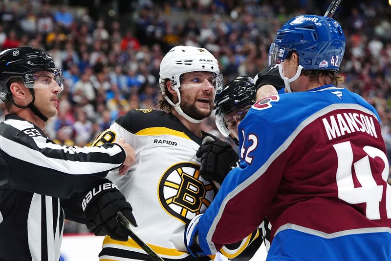 Oct 16, 2024; Denver, Colorado, USA; Boston Bruins center Pavel Zacha (18) and Colorado Avalanche defenseman Josh Manson (42) are pulled apart in the first period at Ball Arena. Mandatory Credit: Ron Chenoy-Imagn Images