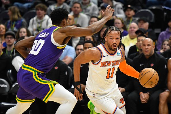 SALT LAKE CITY, UTAH - DECEMBER 13: Jalen Brunson #11 of the New York Knicks drives against Ochai Agbaji #30 of the Utah Jazz during the first half of a game at Delta Center on December 13, 2023 in Salt Lake City, Utah. NOTE TO USER: User expressly acknowledges and agrees that, by downloading and or using this photograph, User is consenting to the terms and conditions of the Getty Images License Agreement. (Photo by Alex Goodlett/Getty Images)