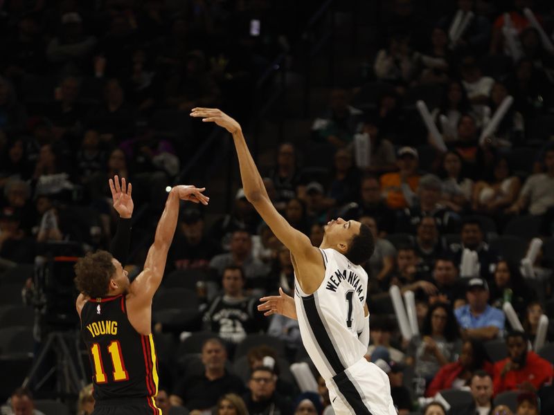 SAN ANTONIO, TX - NOVEMBER 30: Trae Young #11 of the Atlanta Hawks launches a shot over Victor Wembanyama #1 of the San Antonio Spurs in the second half at Frost Bank Center on November 30, 2023 in San Antonio, Texas. NOTE TO USER: User expressly acknowledges and agrees that, by downloading and or using this photograph, User is consenting to terms and conditions of the Getty Images License Agreement. (Photo by Ronald Cortes/Getty Images)
