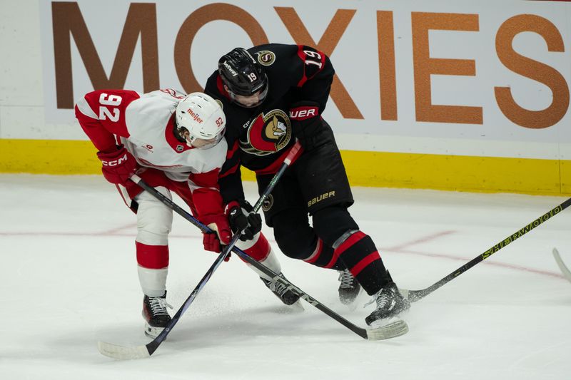 Dec 5, 2024; Ottawa, Ontario, CAN;  Detroit Red Wings center Marco Kasper (92) battles with Ottawa Senators right wing Drake Batherson (19) in the third period at the Canadian Tire Centre. Mandatory Credit: Marc DesRosiers-Imagn Images