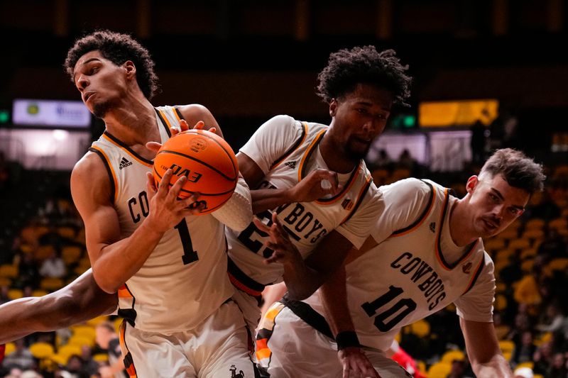 Feb 8, 2023; Laramie, Wyoming, USA; Wyoming Cowboys guard Brendan Wenzel (1) gets the rebound from teammates  Jeremiah Oden (25) and Hunter Thompson (10) against the UNLV Runnin' Rebels during the first half at Arena-Auditorium. Mandatory Credit: Troy Babbitt-USA TODAY Sports
