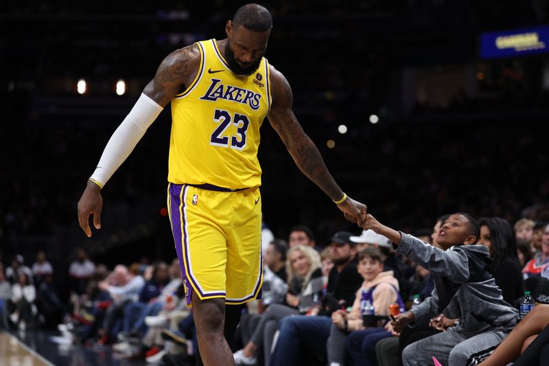 WASHINGTON, DC - APRIL 03: LeBron James #23 of the Los Angeles Lakers greets a fan against the Washington Wizards at Capital One Arena on April 03, 2024 in Washington, DC. NOTE TO USER: User expressly acknowledges and agrees that, by downloading and or using this photograph, User is consenting to the terms and conditions of the Getty Images License Agreement. (Photo by Patrick Smith/Getty Images)