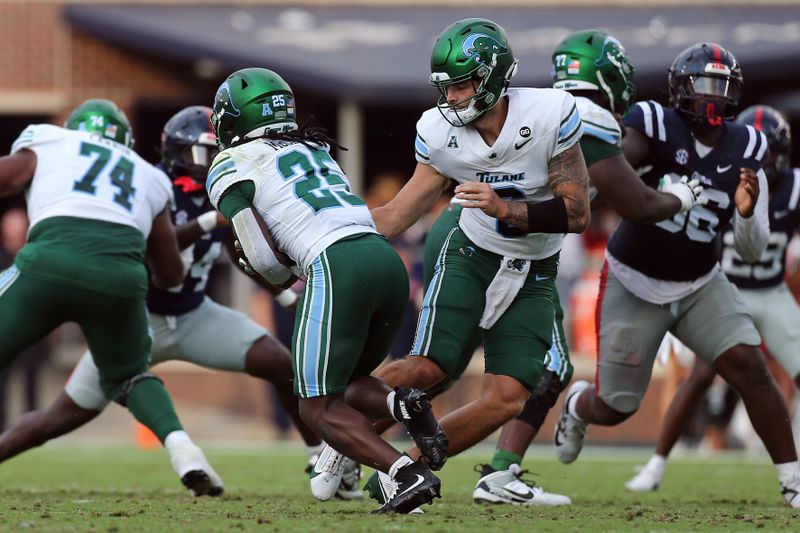 Sep 20, 2025; Oxford, Mississippi, USA; Tulane Green Wave quarterback Brendan Sullivan (6) hands the ball off to running back Jamauri McClure (25) during the fourth quarter against the Mississippi Rebels at Vaught-Hemingway Stadium. Mandatory Credit: Petre Thomas-Imagn Images