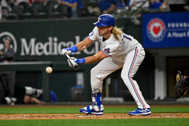 Apr 10, 2024; Arlington, Texas, USA; Texas Rangers designated hitter Travis Jankowski (16) hits a bunt against the Oakland Athletics during the fourth inning at Globe Life Field. Mandatory Credit: Jerome Miron-USA TODAY Sports