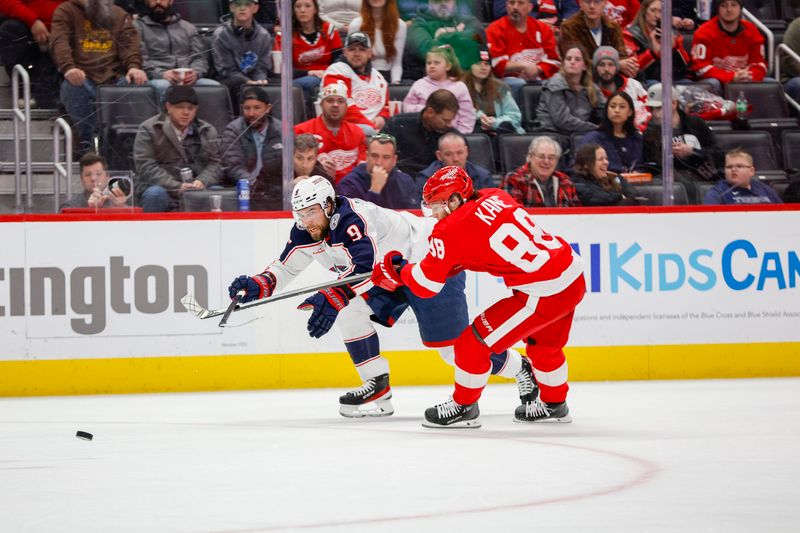 Mar 19, 2024; Detroit, Michigan, USA; Columbus Blue Jackets defenseman Ivan Provorov (9) fights for control of the puck with Detroit Red Wings right wing Patrick Kane (88) during the third period of the game against the Detroit Red Wings at Little Caesars Arena. Mandatory Credit: Brian Bradshaw Sevald-USA TODAY Sports