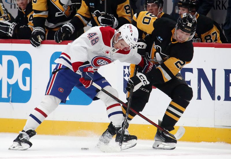 Nov 2, 2024; Pittsburgh, Pennsylvania, USA;  Montreal Canadiens defenseman Lane Hutson (48) and Pittsburgh Penguins center Lars Eller (20) battles for the puck during the first period at PPG Paints Arena. Mandatory Credit: Charles LeClaire-Imagn Images