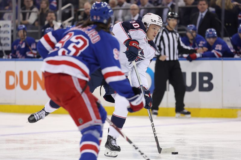 Feb 28, 2024; New York, New York, USA; Columbus Blue Jackets left wing Dmitri Voronkov (10) takes a shot against New York Rangers center Mika Zibanejad (93) during the first period at Madison Square Garden. Mandatory Credit: Brad Penner-USA TODAY Sports