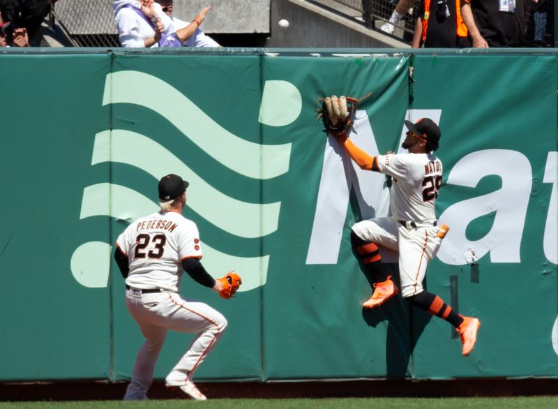 Jul 30, 2023; San Francisco, California, USA; Neither San Francisco Giants left fielder Joc Pederson (23) nor center fielder Luis Matos (29) can catch a home run by Boston Red Sox center fielder Adam Duvall during the seventh inning at Oracle Park. Mandatory Credit: D. Ross Cameron-USA TODAY Sports