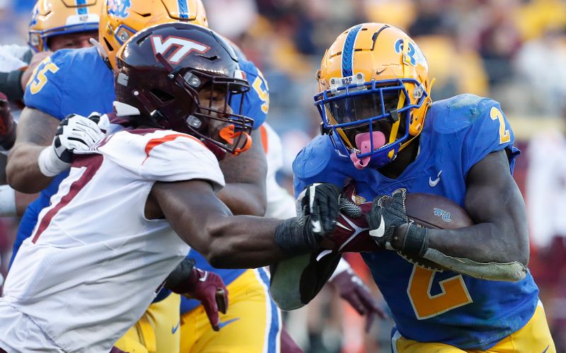 Oct 8, 2022; Pittsburgh, Pennsylvania, USA; Pittsburgh Panthers running back Israel Abanikanda (2) runs on his way to scoring his third touchdown of the game past  Virginia Tech Hokies defensive lineman Cole Nelson (left) during the third quarter at Acrisure Stadium. Mandatory Credit: Charles LeClaire-USA TODAY Sports