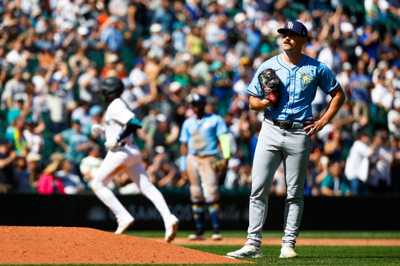 Aug 28, 2024; Seattle, Washington, USA; Tampa Bay Rays relief pitcher Manuel Rodriguez (39) stands behind the mound after surrendering a two-run home run to Seattle Mariners right fielder Victor Robles (10, background left) during the fifth inning at T-Mobile Park. Mandatory Credit: Joe Nicholson-USA TODAY Sports