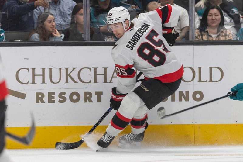 Nov 22, 2025; San Jose, California, USA;  Ottawa Senators defenseman Jake Sanderson (85) controls the puck during the second period against the San Jose Sharks at SAP Center at San Jose. Mandatory Credit: Stan Szeto-Imagn Images