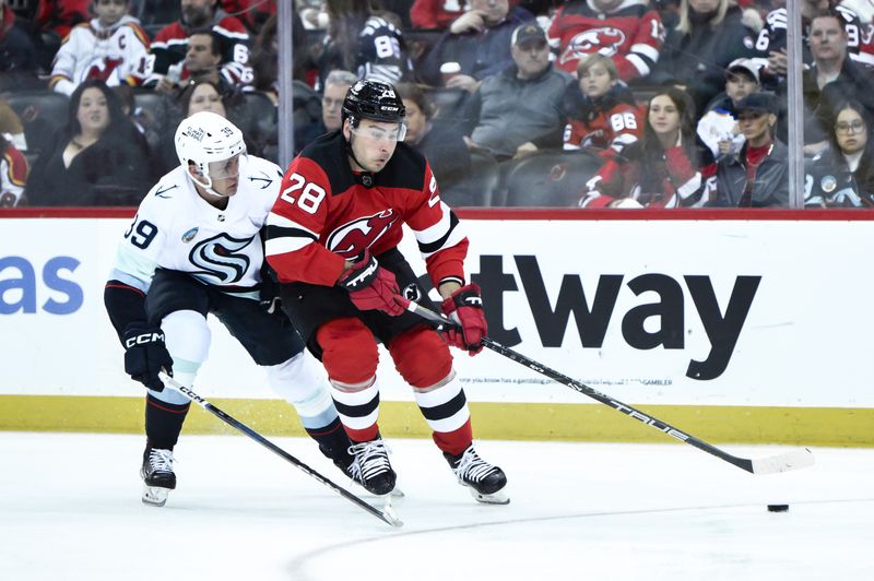 Feb 12, 2024; Newark, New Jersey, USA; New Jersey Devils right wing Timo Meier (28) skates with the puck against Seattle Kraken defenseman Ryker Evans (39) during the second period at Prudential Center. Mandatory Credit: John Jones-USA TODAY Sports