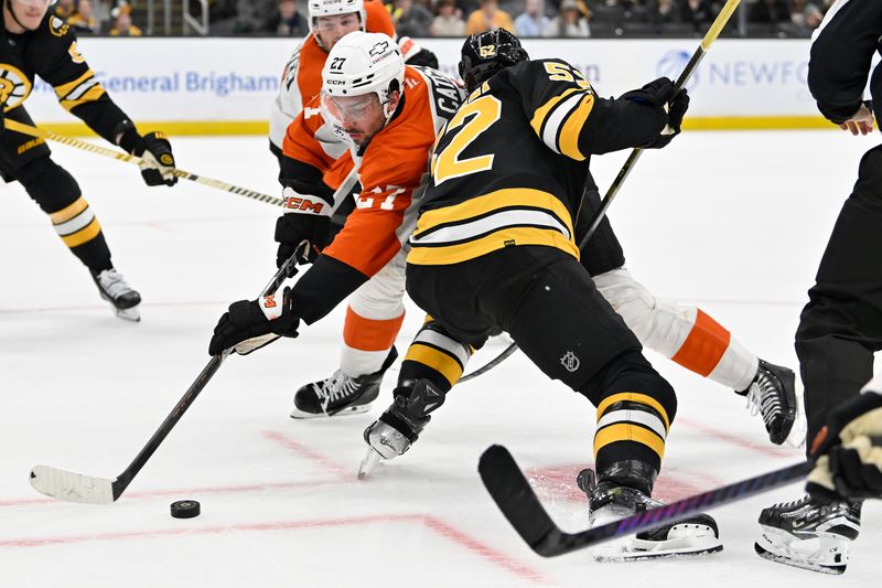 Sep 29, 2025; Boston, Massachusetts, USA;  Philadelphia Flyers left wing Noah Cates (27) battles Boston Bruins center Sean Kuraly (52) in a faceoff during overtime at TD Garden. Mandatory Credit: Eric Canha-Imagn Images