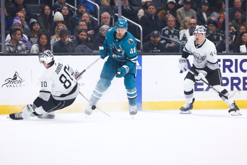 Dec 27, 2023; Los Angeles, California, USA; San Jose Sharks center Tomas Hertl (48) fights for the puck against Los Angeles Kings center Pierre-Luc Dubois (80) during the first period of a game at Crypto.com Arena. Mandatory Credit: Jessica Alcheh-USA TODAY Sports