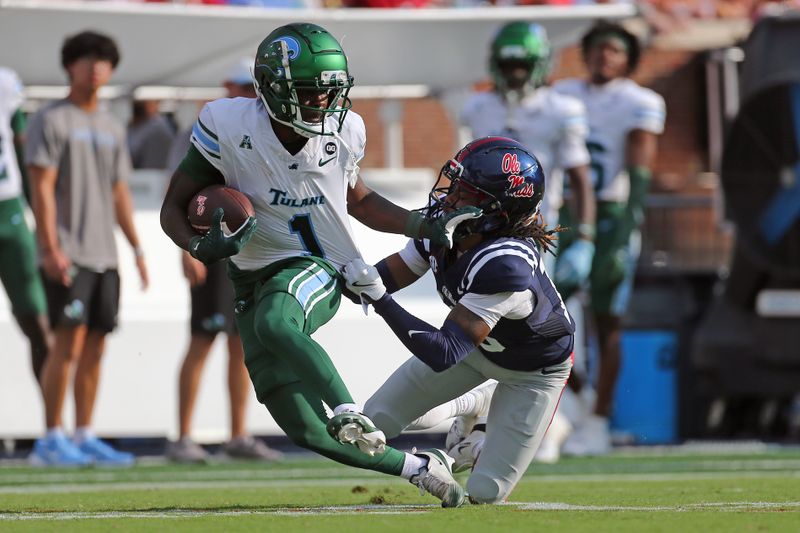 Sep 20, 2025; Oxford, Mississippi, USA; Tulane Green Wave wide receiver Omari Hayes (1) runs after a catch as Mississippi Rebels defensive back Cedrick Beavers (13) makes the tackle during the third quarter at Vaught-Hemingway Stadium. Mandatory Credit: Petre Thomas-Imagn Images