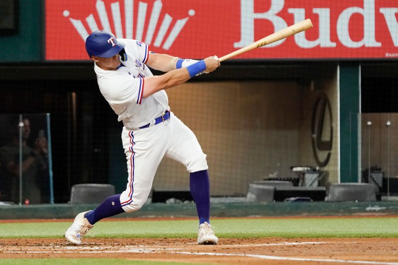 Jun 29, 2023; Arlington, Texas, USA; Texas Rangers third baseman Josh Jung (6) follows thru on an RBI single during the first inning against the Detroit Tigers at Globe Life Field. Mandatory Credit: Raymond Carlin III-USA TODAY Sports