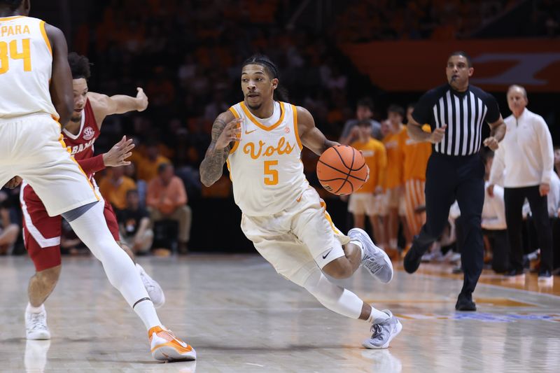 Mar 1, 2025; Knoxville, Tennessee, USA; Tennessee Volunteers guard Zakai Zeigler (5) moves the ball against the Alabama Crimson Tide during the first half at Thompson-Boling Arena at Food City Center. Mandatory Credit: Randy Sartin-Imagn Images