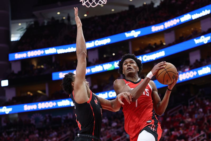 HOUSTON, TEXAS - FEBRUARY 09: Amen Thompson #1 of the Houston Rockets goes up against Scottie Barnes #4 of the Toronto Raptors during the first half at Toyota Center on February 09, 2025 in Houston, Texas. NOTE TO USER: User expressly acknowledges and agrees that, by downloading and or using this photograph, User is consenting to the terms and conditions of the Getty Images License Agreement. (Photo by Alex Slitz/Getty Images)