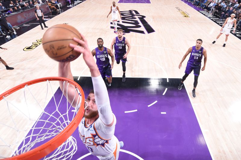 SACRAMENTO, CA - APRIL 12: Jusuf Nurkic #20 of the Phoenix Suns drives to the basket during the game against the Sacramento Kings on April 12, 2024 at Golden 1 Center in Sacramento, California. NOTE TO USER: User expressly acknowledges and agrees that, by downloading and or using this Photograph, user is consenting to the terms and conditions of the Getty Images License Agreement. Mandatory Copyright Notice: Copyright 2024 NBAE (Photo by Rocky Widner/NBAE via Getty Images)