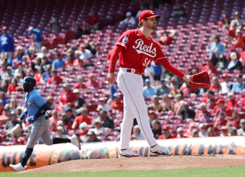 Apr 19, 2023; Cincinnati, Ohio, USA; Cincinnati Reds starting pitcher Levi Stoudt (58) waits for a new ball as Tampa Bay Rays first baseman Yandy Diaz (left) runs the bases after hitting a solo home run during the first inning at Great American Ball Park. Mandatory Credit: David Kohl-USA TODAY Sports