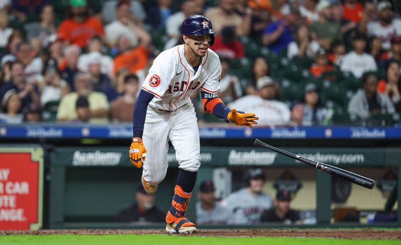 May 2, 2024; Houston, Texas, USA; Houston Astros left fielder Mauricio Dubon (14) hits a single during the third inning against the Cleveland Guardians at Minute Maid Park. Mandatory Credit: Troy Taormina-USA TODAY Sports