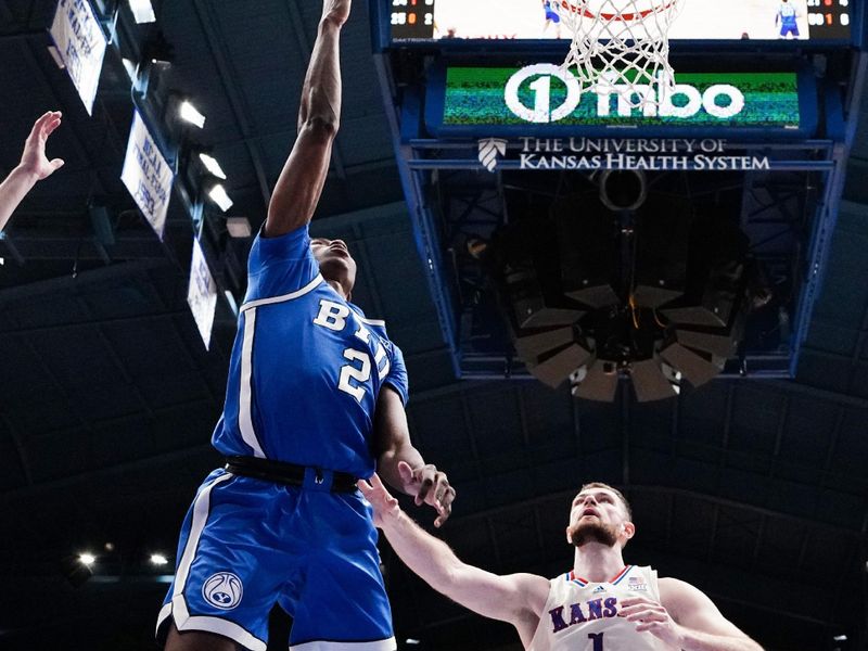 Feb 27, 2024; Lawrence, Kansas, USA; Brigham Young Cougars guard Jaxson Robinson (2) shoots as Kansas Jayhawks center Hunter Dickinson (1) defends during the second half at Allen Fieldhouse. Mandatory Credit: Denny Medley-USA TODAY Sports