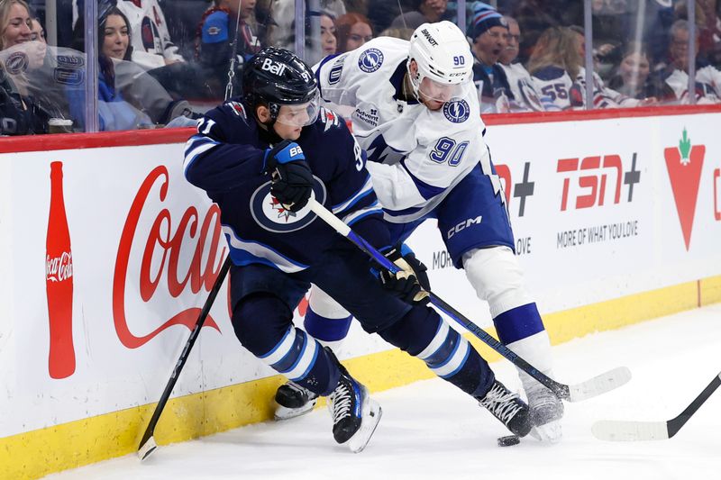 Nov 3, 2024; Winnipeg, Manitoba, CAN; Winnipeg Jets center Cole Perfetti (91) is checked by Tampa Bay Lightning defenseman J.J. Moser (90) in the second period at Canada Life Centre. Mandatory Credit: James Carey Lauder-Imagn Images