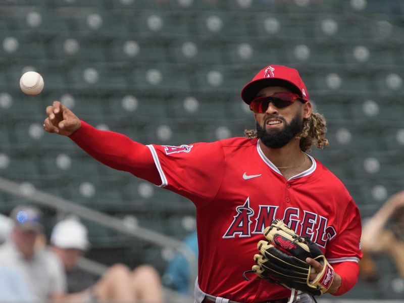 Mar 23, 2024; Mesa, Arizona, USA; Los Angeles Angels third baseman Hunter Dozier (17) makes the off balance throw for an out against the Oakland Athletics in the first inning at Hohokam Stadium. Mandatory Credit: Rick Scuteri-USA TODAY Sports