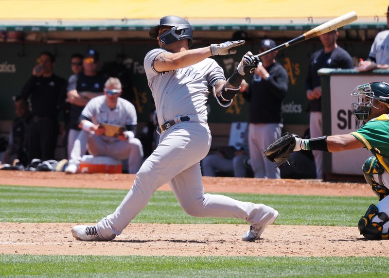 Jun 29, 2023; Oakland, California, USA; New York Yankees  designated hitter Gleyber Torres (25) hits a single against the Oakland Athletics during the fifth inning at Oakland-Alameda County Coliseum. Mandatory Credit: Kelley L Cox-USA TODAY Sports