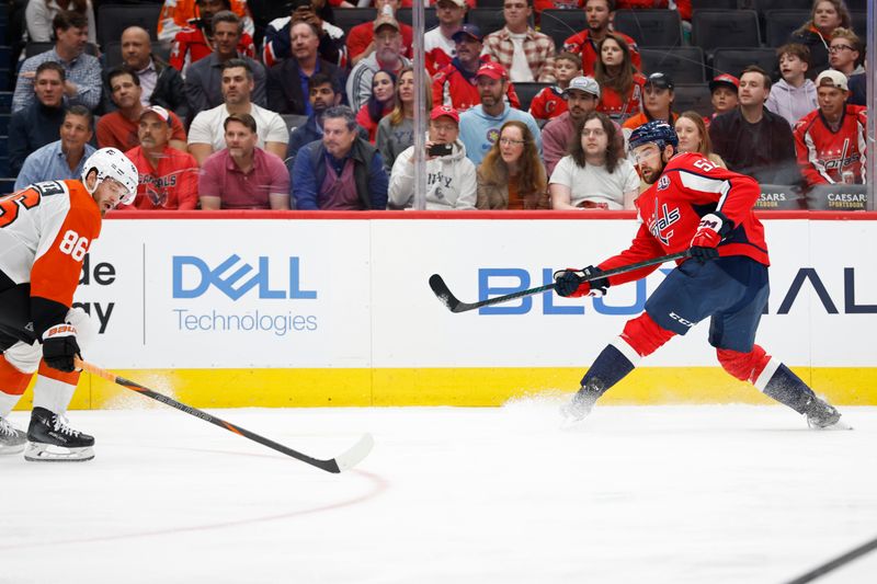 Oct 23, 2024; Washington, District of Columbia, USA; Washington Capitals defenseman Dylan McIlrath (52) shoots the puck on goal as Philadelphia Flyers left wing Joel Farabee (86) defends in the first period at Capital One Arena. Mandatory Credit: Geoff Burke-Imagn Images