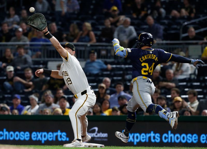 Sep 25, 2024; Pittsburgh, Pennsylvania, USA;  Pittsburgh Pirates first baseman Jared Triolo (19) catches the ball at first base to retire Milwaukee Brewers catcher William Contreras (24) during the ninth inning at PNC Park. Mandatory Credit: Charles LeClaire-Imagn Images