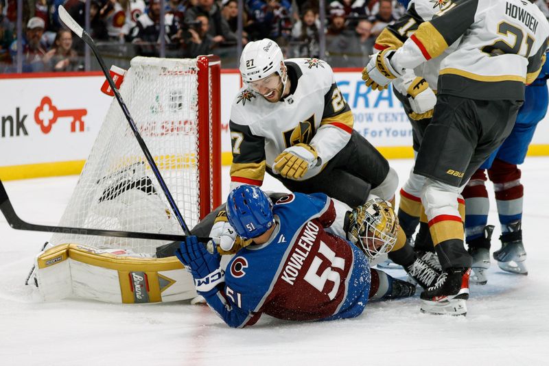 Nov 27, 2024; Denver, Colorado, USA; Colorado Avalanche right wing Nikolai Kovalenko (51) collides with Vegas Golden Knights goaltender Adin Hill (33) as defenseman Shea Theodore (27) falls over them in the second period at Ball Arena. Mandatory Credit: Isaiah J. Downing-Imagn Images