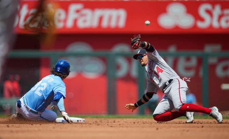May 28, 2023; Kansas City, Missouri, USA; Washington Nationals second baseman Ildemaro Vargas (14) is unable to make the catch as Kansas City Royals left fielder Nick Pratto (32) slides into second base for a double during the first inning at Kauffman Stadium. Mandatory Credit: Jay Biggerstaff-USA TODAY Sports